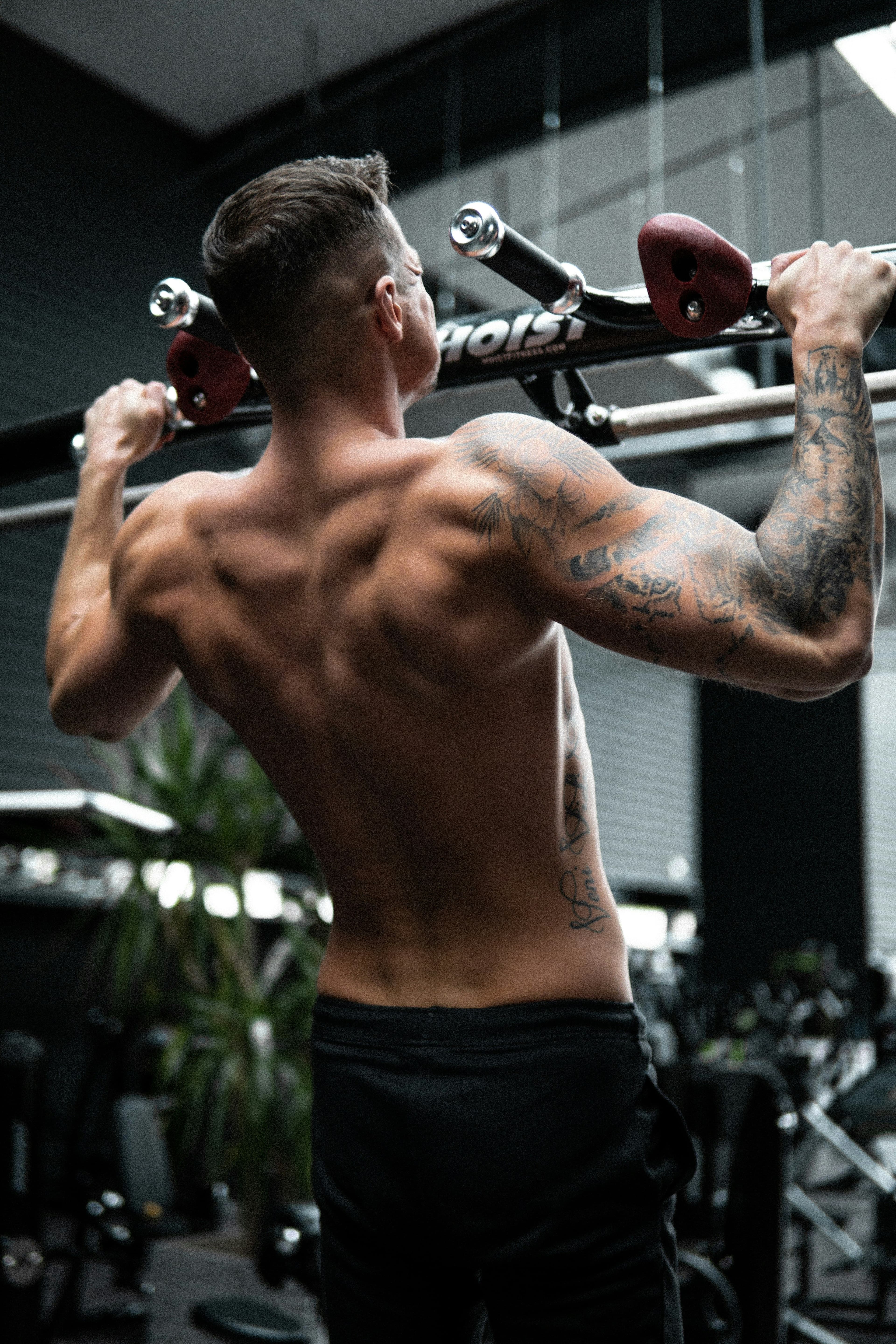 An athlete mid pull-up, building back and grip strength